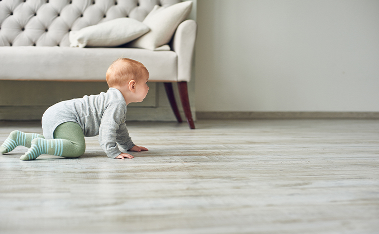 sheet vinyl flooring with grey couch