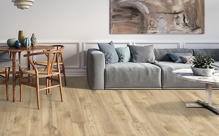 wood look laminate flooring in living room with grey couch and dining table